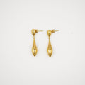 Pair of gold earrings on a light gray background